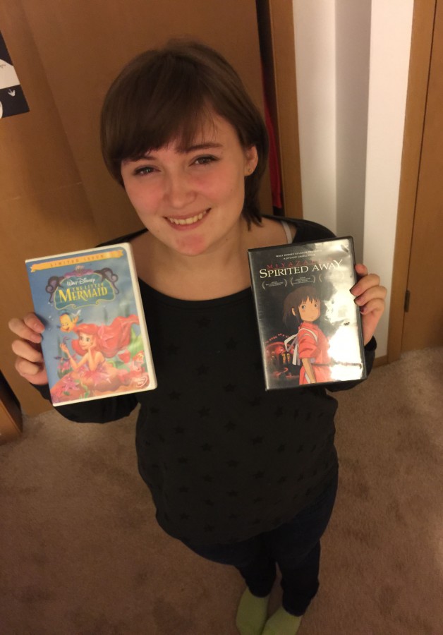Sara Imbrie, junior, poses with copies of two movies that she adores: The Little Mermaid and Spirited Away. Growing up, she watched these films with delight numerous times, having really related to the main heroines in each. I feel like these girls are good role models, she explained. 