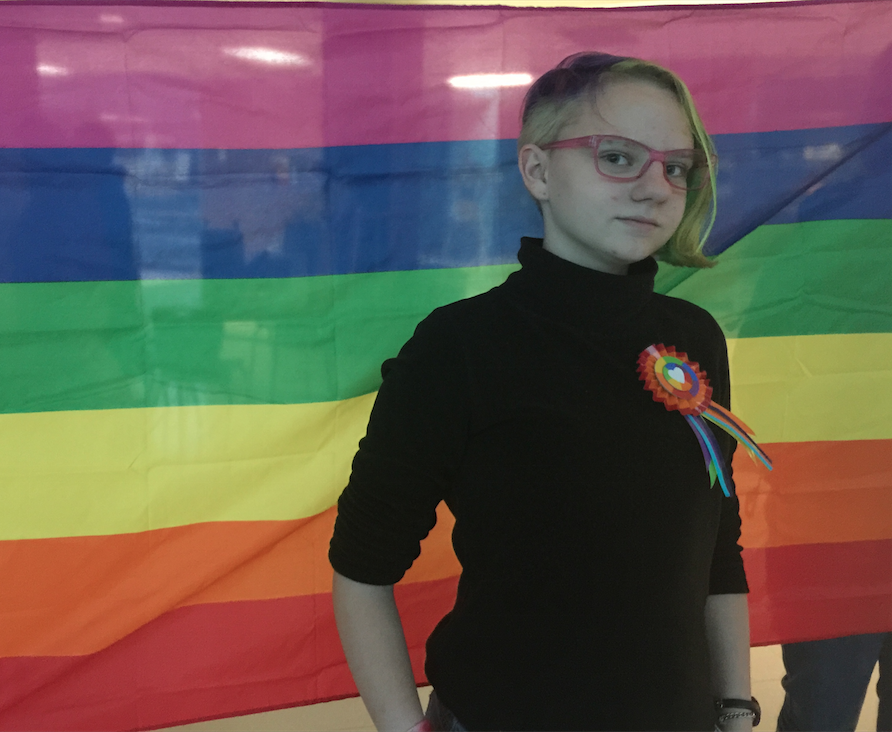 Jenna+Buraczewski%2C+sophomore+and+cofounder+of+the+GSA%2C+poses+in+front+of+the+club%E2%80%99s+rainbow+flag.+Buraczewski+and+Sam+Ginkel%2C+senior+and+cofounder+of+the+GSA%2C+restarted+the+club+a+year+after+it+was+disbanded+during+the+school+year+of+2013+and+2014.+%E2%80%9CI+really+like+the+unity+that+the+GSA+promotes%2C%E2%80%9D+she+said.