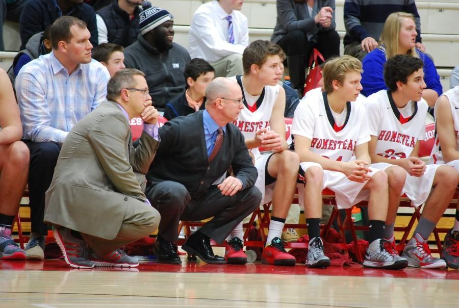 Head Coach Kevin McKenna, Assistant Coach Steven O’Brien, number 10, Jacob Urban, junior, number 11, Noah Check, and number 33, Justen Newby, junior, all look on from the bench as Homestead rolled over Port Washington 47-29 on Dec. 5..
