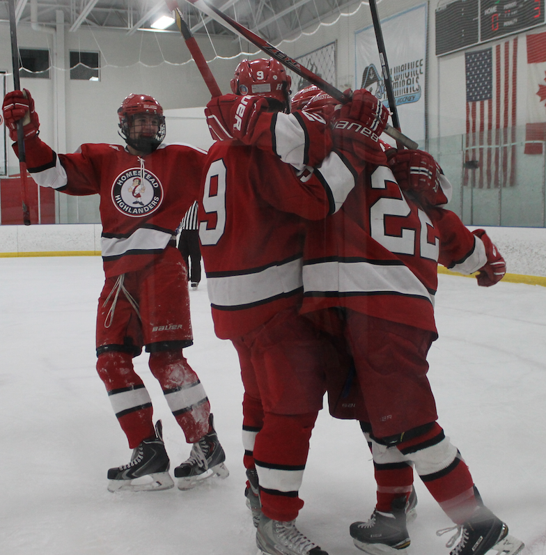 Number 22, Joey Hobbs, junior, number 9, Nathan Schimpf, sophomore and number 14, Cole Simpson, senior, celebrate after scoring a goal against the Brookfield Stars in a game ending with a score of 5-3, Highlanders. Homestead is undefeated to start the season. “We came out on top which is always good but we need to continue to work and practice for our victories,” Hobbs said.