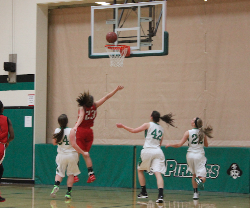 Chloe Marotta, freshman, jumps up and tries to block her opponents shot. The ball had gone in the hoop, which scored one point for Port.  “How we play and work together as a team, really helps us to win games,” Marotta said.