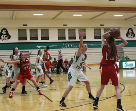 Madeline McDonald, junior, looks for an open teammate as Marotta fights for her position near the paint. 
