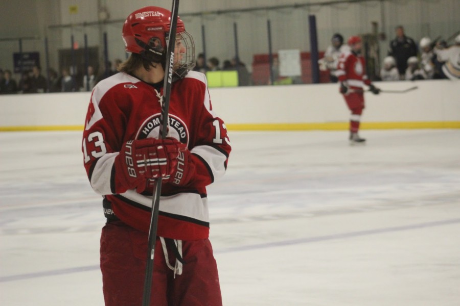Number 13, Will Gebhardt, senior, looks on as he gets ready for the face off in the hockey teams 4-0 loss against University School of Milwaukee on Tuesday. 