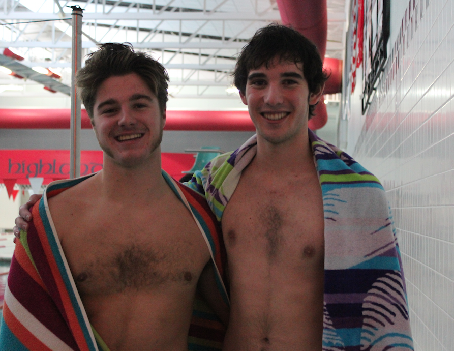 Happ and Callahan smile during a meet against Port Washington. The boys won that meet and hope to achieve victory against Cedarburg, one of their toughest opponents, tomorrow. “The competition will be intense,” Happ said. 