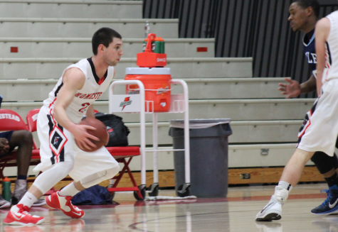 Jack Popp, junior, makes a move before driving towards the basket.  Popp has played on varsity for three years now