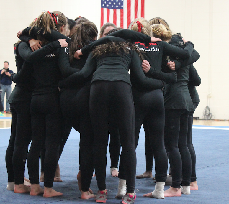 The+girls+are+huddling+together+before+they+face+off+against+Cedarburg+and+Grafton.+Homestead+won+this+meet+by+one+point.+%E2%80%9CIt+was+so+great+to+start+off+with+a+win%2C+and+Im+excited+to+see+whats+in+store+for+the+rest+of+the+season%2C%E2%80%9D+Rachel+Laabs%2C+senior%2C+said.