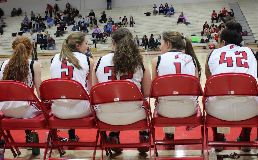 The girls’ basketball team cheer each other on during a game against Oconomowoc. Erin Gifford, junior stated that winning is a team effort. “Whether you’re playing, or sitting on the bench, every position is important,” Gifford said.
