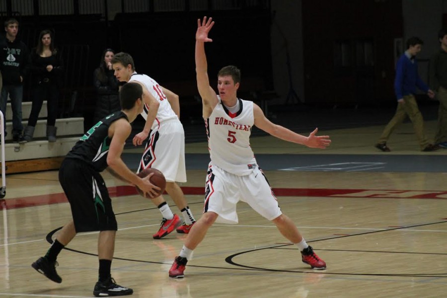 Mitch Sutton, number 5, senior, plays defense in a 47-29 win against conference rival Port Washington on December 5.