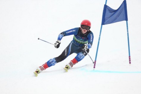 As Heilmann skis down the slope, he continues to go around the flags.