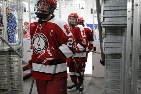 Adam Hobbs, senior, and Andy Buchanan, sophomore, come off the ice happy after beating Brookfield 5-3.