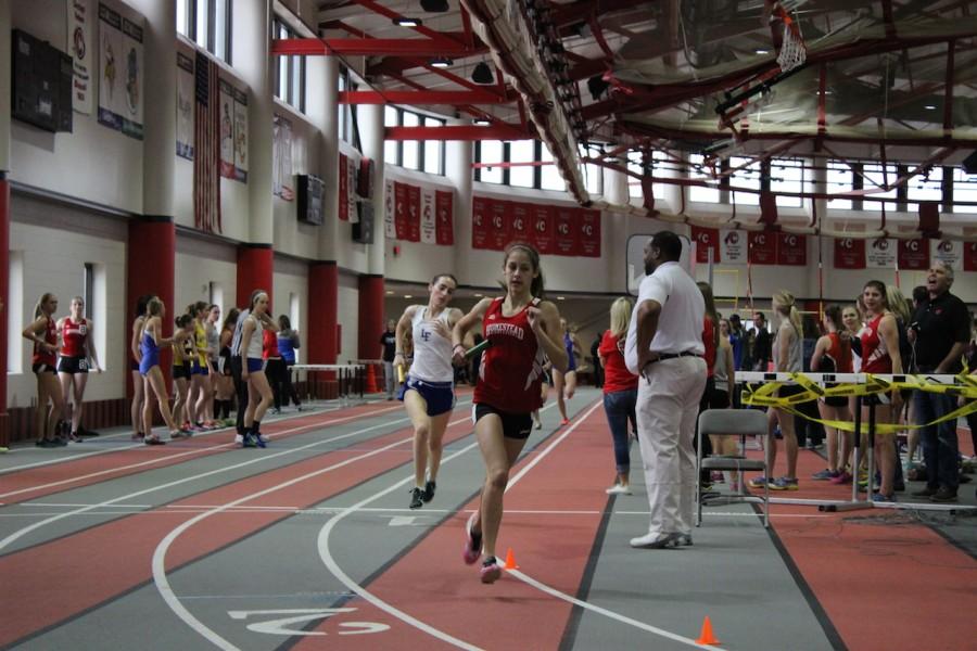 Allie Levin, sophomore,  competes in the 4 by 800 meter run at Carthage last weekend.
