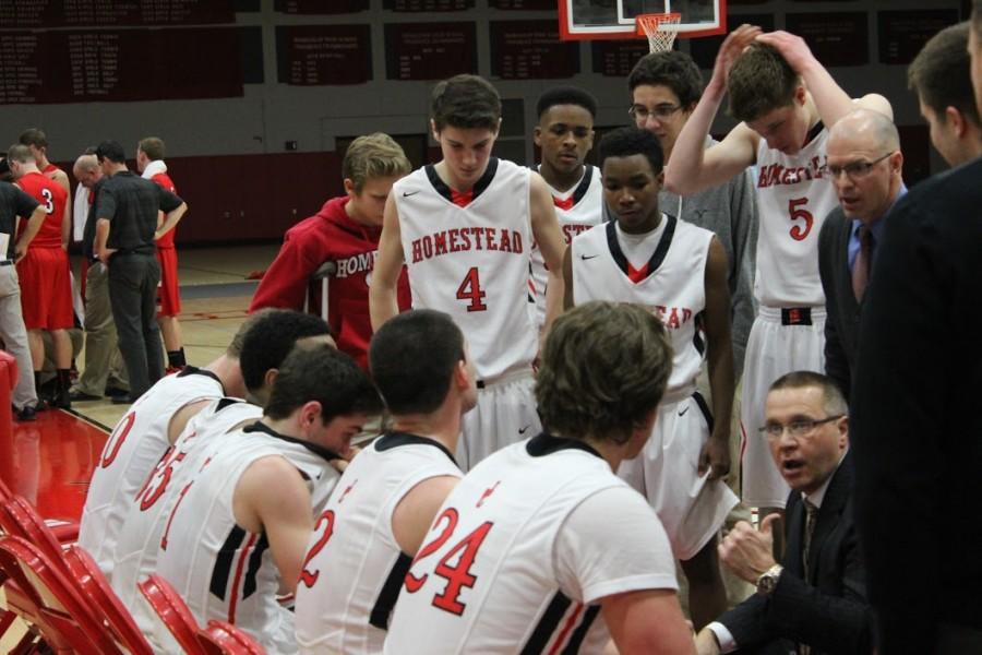 The boys basketball team circles up during a timeout in the first round of playoffs. Overall it was a good win and we hope to continue our success tonight against Arrowhead, Jake Lapin, senior, said