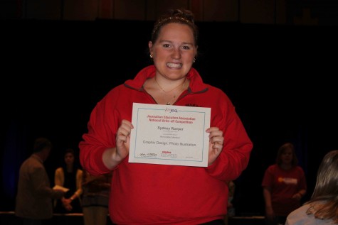 Sydney Roeper, junior, holds her certificate after winning Honorable Mention in the category of Graphic Design: Photo Illustration at the 2015 Spring National High School Journalism Convention in Denver, CO. Roeper went to Washington DC for the fall convention as well. “I was so excited when my name was called for honorable mention. I worked really hard on my design and it paid off,” Roeper said. 
