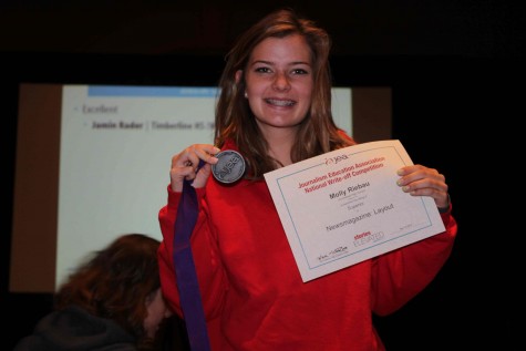 Molly Riebau, junior, smiles happily with her medal and certificate after winning the superior award for Newsmagazine: layout. This was Riebaus third convention but first time she won a superior. “Winning the superior award for magazine design is the first thing I have ever won on my own, not on a team. It’s cool to be recognized as an individual for the work that I did,” Riebau said.