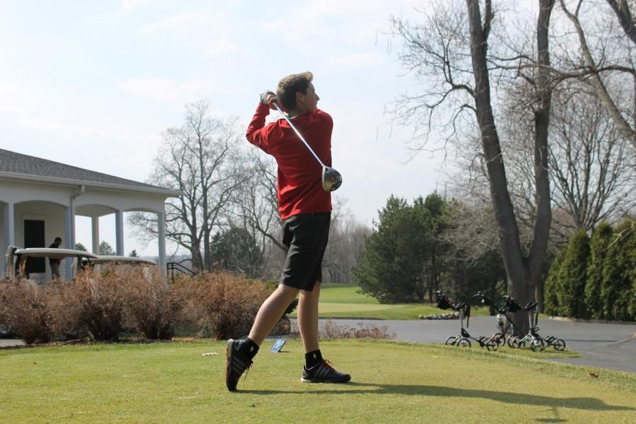 Robbie Morway, sophomore, tees off during practice at Ozaukee Country Club.