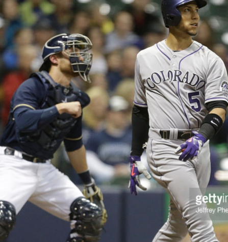In an image characteristic of the Brewers start to the season, Carlos Gonzalez, Rockies outfielder, looks at his home run in the eighth inning of Wednesdays game at Miller Park as Jonathan Lucroy, Brewers catcher, can merely gander at the shot. The Rockies would win the game 5-4 in 10 innings. Photo provided by Getty Images
