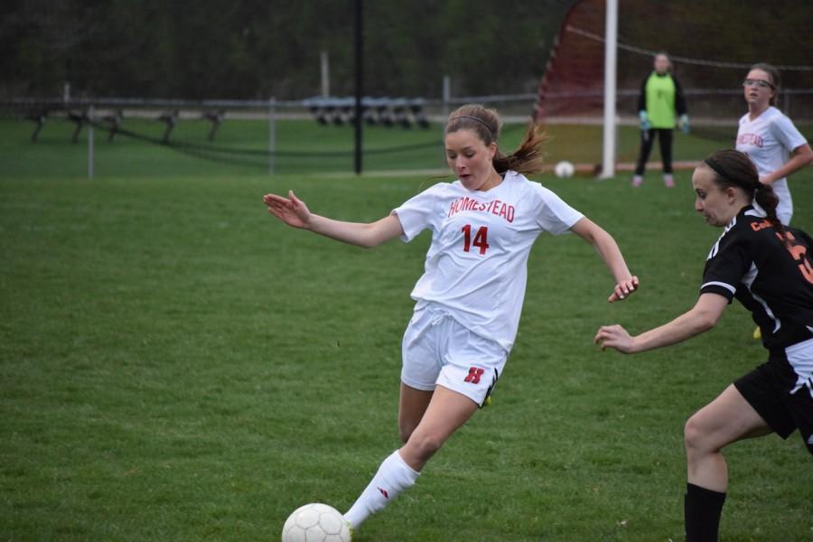 Sara Wirthlin, junior,  clears the ball in a recent game at Homestead.