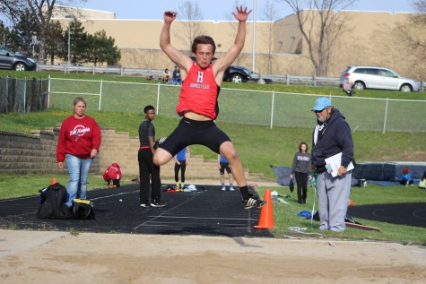 Jake Bruner, junior, competes in the Long Jump relay in which he helped the team place first in.