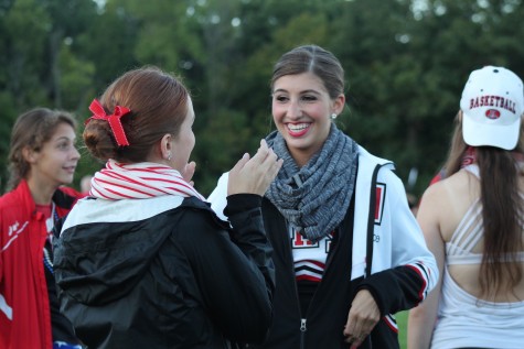 (From left) Meredith Clark, junior, and Simah Lewinsky, senior, add excitement to the tailgate. Dressed in their uniforms, they prepare for the varsity dance team's performance.