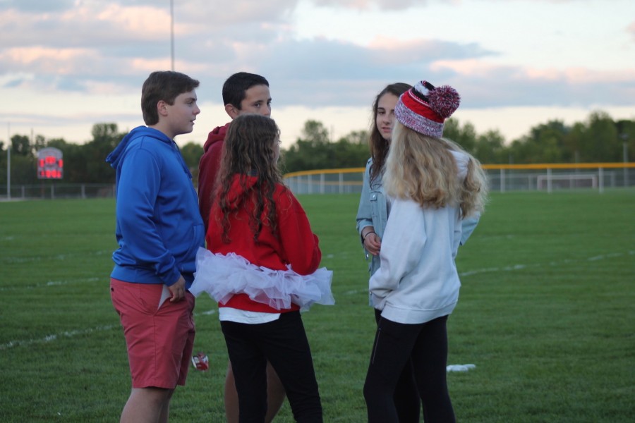Freshmen chat among each other at the Tailgate. Prepared for the football game, this group donned their patriotic attire.