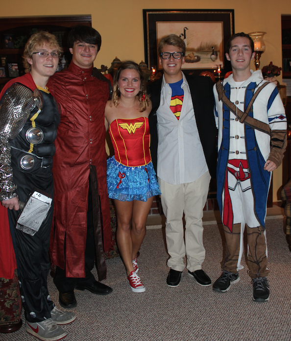 Graduated Homestead students pose for the camera in last years superhero theme. Although the themes have changed, Homecoming traditions have remained the same  every year to maintain school spirit. 
