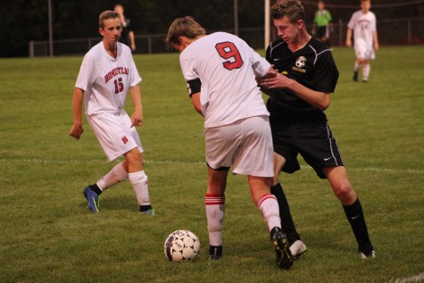 Number 9, Doug Kellner, senior, fights for the ball with a Germantown player.