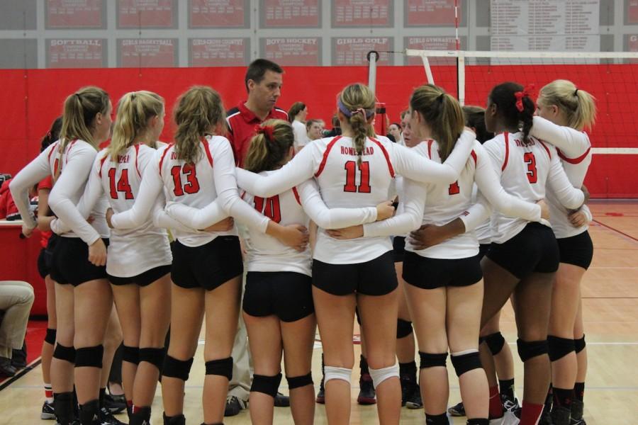 The varsity girls volleyball team huddles around each other as they get ready to take on Cedarburg on Tues, Oct. 13.