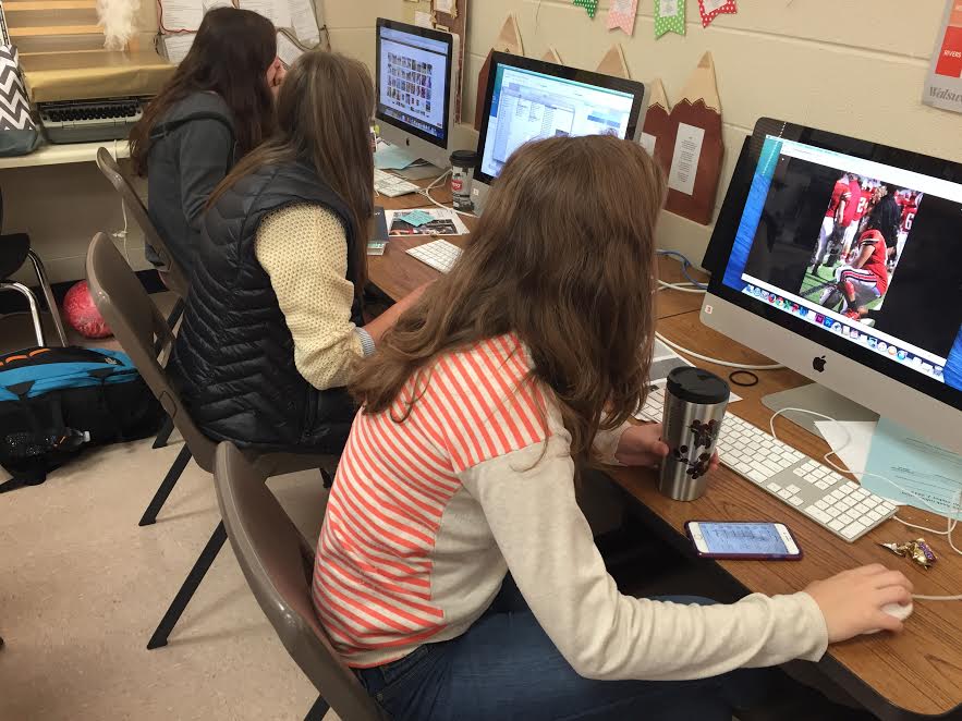 Students work on yearbook spreads during first hour in room 405.  Spreads have been due every few weeks this trimester to ensure a finished yearbook.  I cant wait to see the finished copy, Emma Wade, senior, said.  I also cant wait to see how the new staffers do next year.