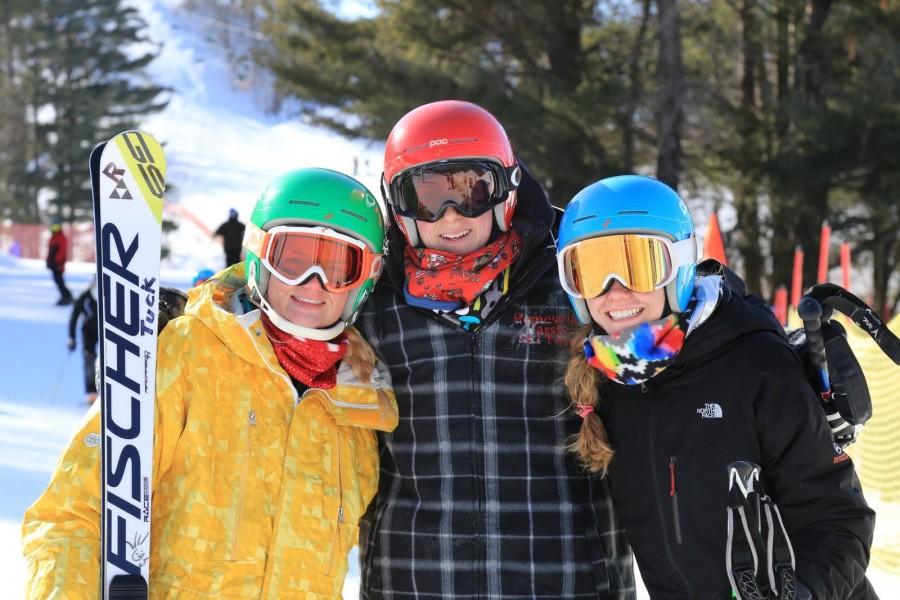 (Left to right) Lizzy Tucker, junior, Jake Heilmann, graduated, and Charlotte Doering, junior, smile for a photo at a race. All three of these athletes qualified for the state tournament last season.