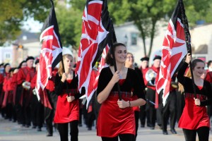 Sarah Sullivan, sophomore, takes in the sights and sounds of the Homecoming parade as a part of color guard.