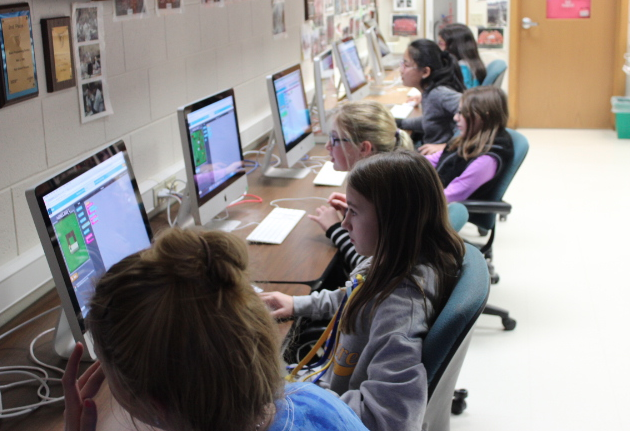 Computer science room: The girls worked with Ms. Kathleen Connelly and Mr. Scott Nettesheim, computer science teachers, and Fiona Grady, senior, to learn how to code a program. 