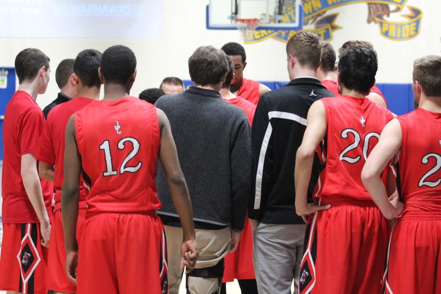 The boys huddle around the coach in last years matchup against Germantown.