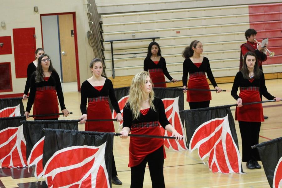 Emma Foulkes, senior color guard captain, stands ready with her flags crew at the Sounds of the Stadium concert in Homesteads main gym.