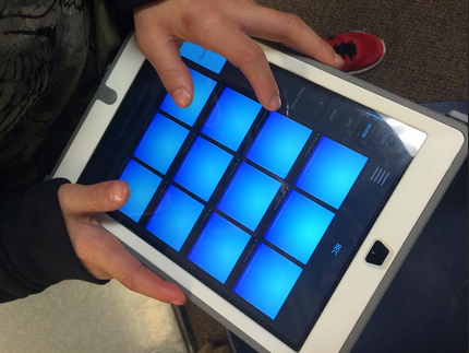The boys use iPads to create the background music to their songs. 