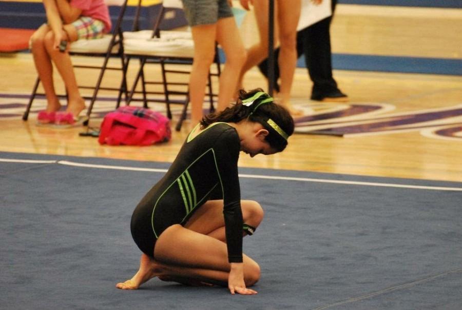 Thirteen-year-old Gaby Geiger performs her floor routine at a club gymnastics meet. 