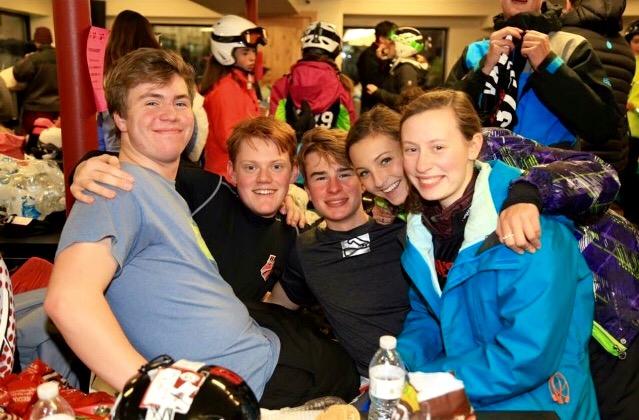 Waszkiewics and ski teammates pose for a photo in the lodge during a race.
