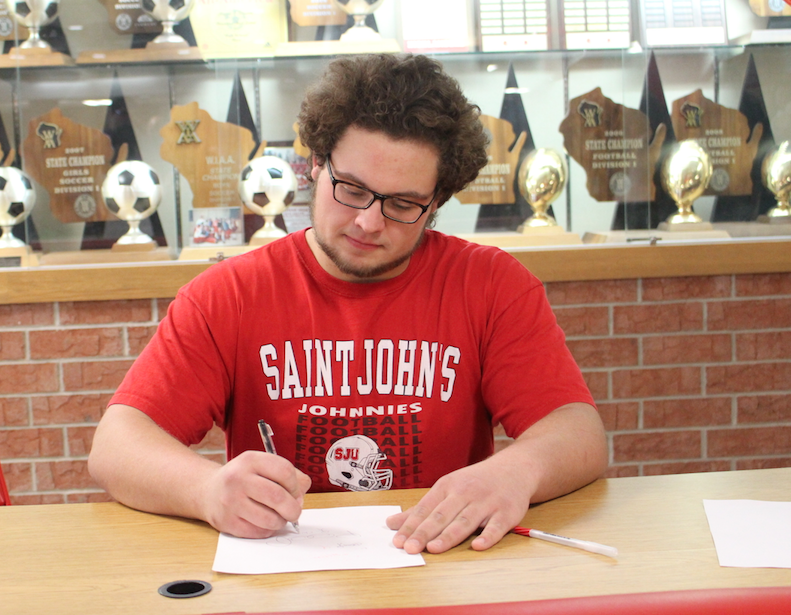 Chris Malicky, senior football player, committed to St. Johns University in Minnesota to continue his football career. 