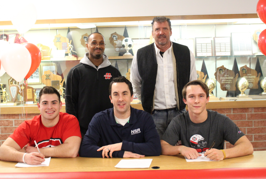 Football players Matt Winters and Jake Bruner, seniors, both committed to play football for St. Cloud State University, pose with Coach Leonard Carter, Robert Bruner as well as their agent from a scouting company. 