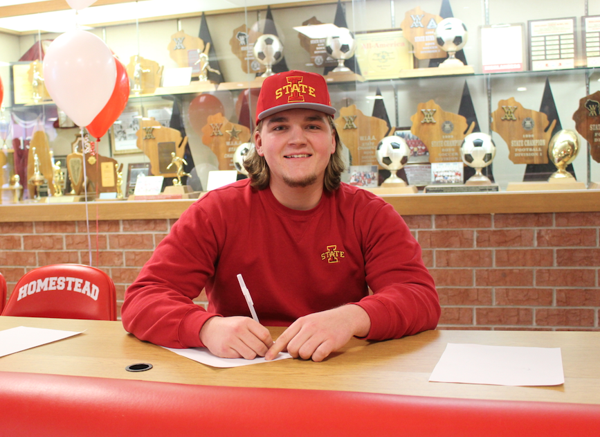 Josh Mueller, senior, smiles after signing a National Letter of Intent to play Division I football for Iowa State University. 