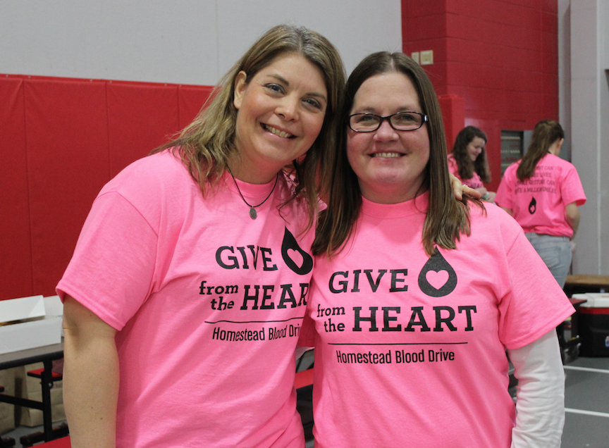 Ms. Pfaff and Ms. Maslowski sport blood drive t-shirts. 