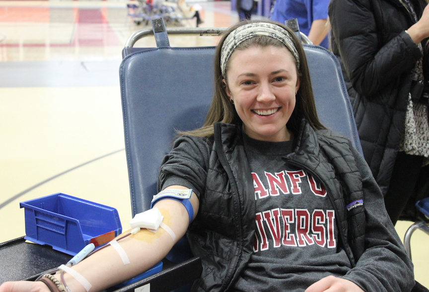 Kristen Gebhardt, senior smiles through the pain of the needle in her arm. 