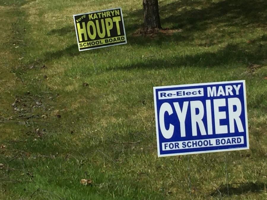 A+Mequon+resident+places+up+signs+in+support+of+the+reelection+of+incumbents+Ms.+Mary+Cyrier+and+Ms.+Kathryn+Houpt+for+the+Mequon-Thiensville+School+Board.+With+the+upcoming+elections+in+Mequon+on+April+5%2C+many+began+putting+up+signs+in+support+of+their+favored+candidates.+Photo+by+Madina+Jenks.+
