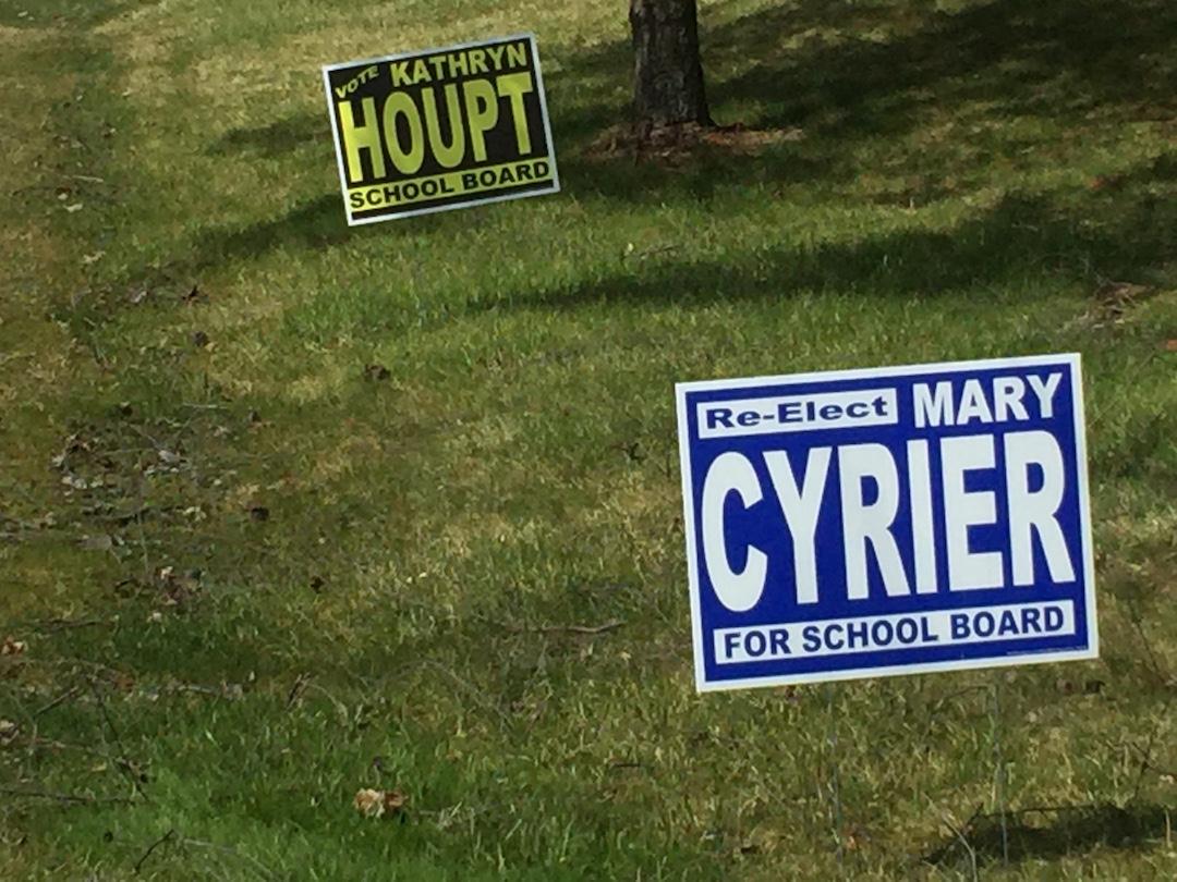 A Mequon resident places up signs in support of the reelection of incumbents Ms. Mary Cyrier and Ms. Kathryn Houpt for the Mequon-Thiensville School Board. With the upcoming elections in Mequon on April 5, many began putting up signs in support of their favored candidates. Photo by Madina Jenks.