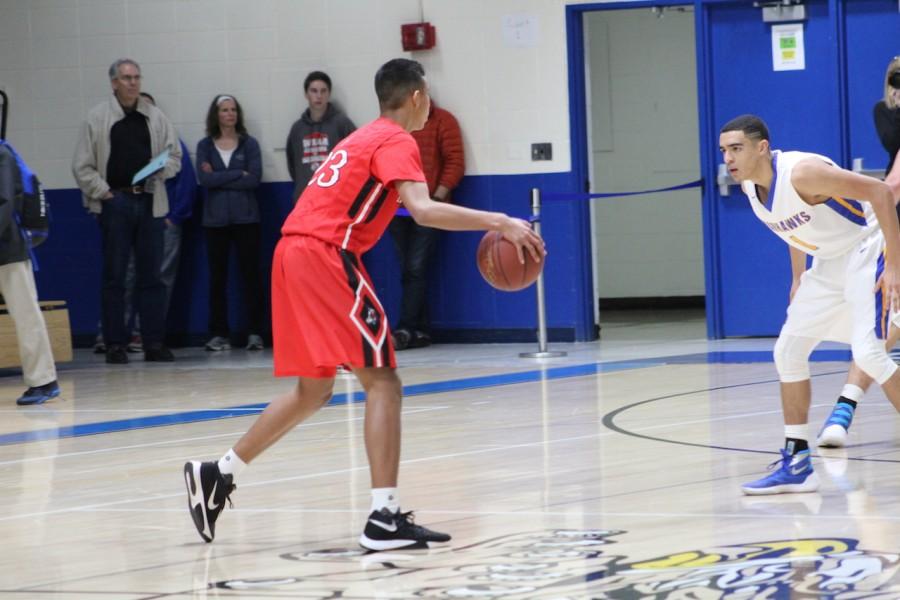 Number 23, Greg Foster, sophomore, dribbles the ball up the court in the loss to Germantown on Feb. 2.