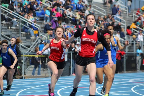 Ellie Hetrick, Senior, receives a hand off from Savannah Melan, Sophomore in the girls 4x200 meter relay. The relay team consisted of Hetrick, Melan, Grace Karegennas, Junior, and Mary Kate Simon, Senior and placed second.