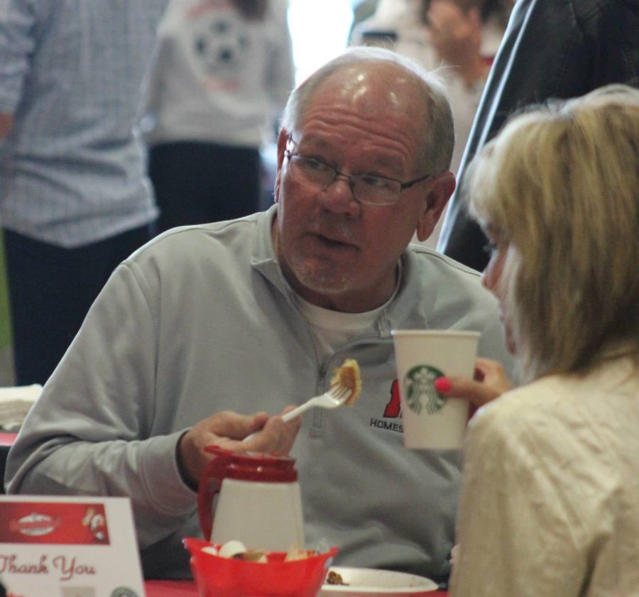 Coach Dave Keel eats and mingles with the community at the Fourth Annual Pancake Breakfast. 