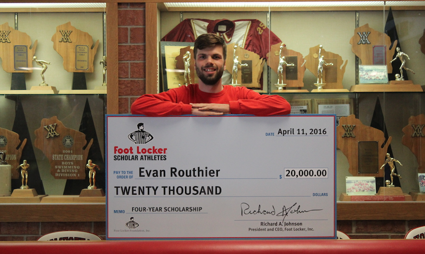 Evan Routhier, senior poses with his check awarded to him by Foot Locker through their Scholar Athletes program. 