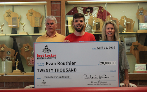 Evan Routhier, senior, poses with his parents and his $20,000 check. 