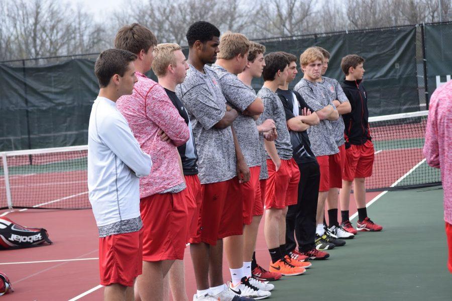 The boys tennis team lines up before the match.