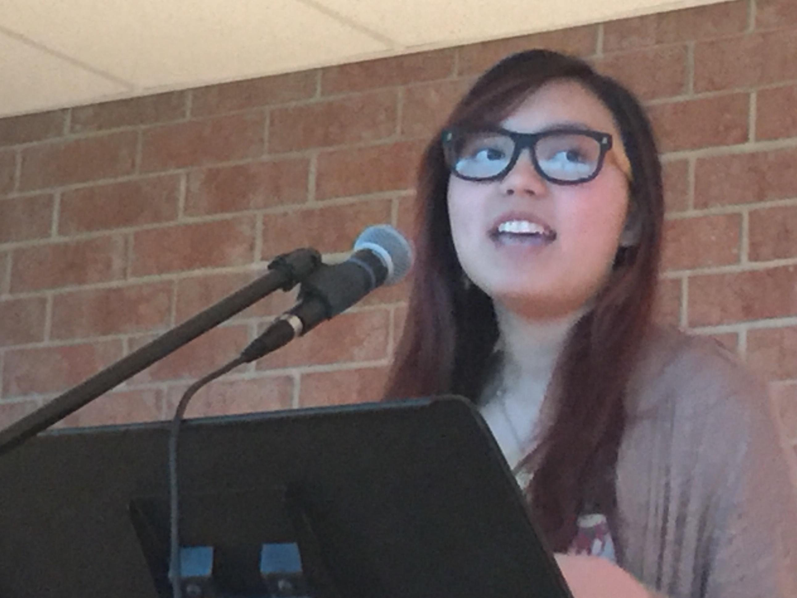 Jenny Lietz, junior, performs a poem at HHS Unplugged. Lietz wrote the poem an hour before the event began. "I wrote it because I was just really getting fed up with jerks being jerks," Lietz remarked. 